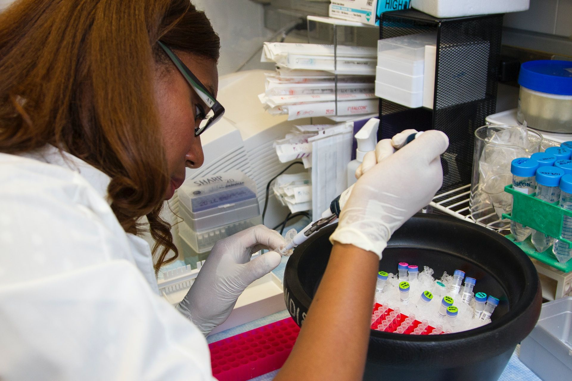 Researcher working with test tube of sample.